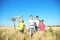 Cute little children with kite in field on sunny day