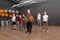 Cute little children and trainer doing physical exercise in school gym