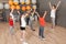 Cute little children and trainer doing physical exercise in school gym