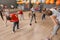 Cute little children and trainer doing physical exercise in school gym