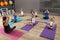 Cute little children and trainer doing physical exercise in school gym