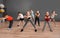 Cute little children and trainer doing physical exercise in school gym