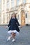 Cute little dance girl in school uniform make curtsy outdoors, dancing