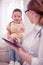 Cute little dark-haired girl listening to family practitioner attentively