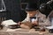 Cute little detective reading old book indoors