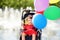 Cute little disabled girl in a wheelchair celebrate birthday or walking in the Park summer. Child cerebral palsy. Inclusion