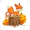 Cute little fox stands on a big stump next to an autumn bush