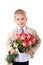 Cute little gentleman standing with big bouquet of red roses