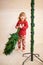 Cute little girl assembling christmas tree.