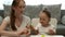 Cute little girl and attractive young mother play plasticine