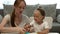 Cute little girl and attractive young mother play plasticine