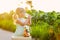 Cute little girl with blonde hair drinking lemonade outdoor. Detox fruit infused flavored water, cocktail in a beverage dispenser