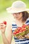 Cute little girl with bowl full of fresh strawberries. Pre - teen girl with glasses and teeth - dental braces