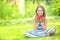 Cute little girl with bowl full of fresh strawberries. Pre - teen girl with glasses and teeth - dental braces