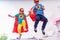 Cute little girl and boy jumping from bed to fly, play superhero