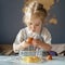 Cute little girl breaking eggs into bowl while cooking with mom