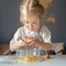 Cute little girl breaking eggs into bowl while cooking with mom