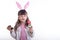 Cute little girl with bunny ears holding Easter egg on white background. Child Smiling Easter Holiday Concept.