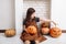 Cute little girl with carving pumpkins. Happy family preparing for Halloween. Funny kid at home