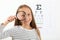 Cute little girl checks eyesight with an ophthalmologist. eyesight test
