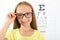 Cute little girl checks eyesight with an ophthalmologist. eyesight test