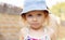 Cute little girl child portrait in blue denim panama at summer. Curvy blonde caucasian sad, serious girl. Happy childhood in