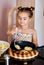 Cute little girl cooking potato pancakes