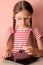 Cute little girl decorates a cake.