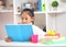 Cute little girl doing homework reading a book coloring pages writing and painting. Children paint. Kids