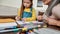 Cute little girl drawing in album together with grandmother