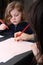 Cute little girl drawing with her mother.