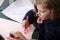 Cute little girl drawing with her mother.