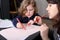 Cute little girl drawing with her mother.