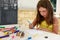 Cute little girl drawing and painting at kindergarten. Creative activities kids club