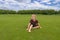 Cute little girl in dress on grass at green park. Summer portrait of baby 3 tree years old