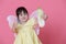 Cute little girl dress up as a angel with white wings holding cabbage and thumb up.Healthy eating and lifestyle concept. Green