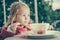 Cute little girl eating fries and tomato sauce