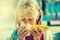 Cute little girl eating sweet corn.Toned photo