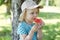 cute little girl eating watermelon outdoors in summertime. Child and watermelon in summer.