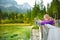 Cute little girl enjoying the view of wonderful green waters of Hintersee lake. Amazing autumn landscape of Bavarian Alps on the A