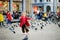 Cute little girl feeding and chasing birds on Dam Square in Amsterdam on summer day