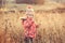 Cute little girl in a field at sunset