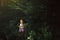 Cute little girl in the forest alone. Fairy tale beautiful light