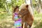 Cute Little Girl Giving Her Pony a Carrot