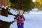 cute little girl is going skate outdoors