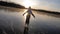 Cute little girl is going skate outdoors at sunset. A schoolgirl enjoying ice skating at frozen lake in winter season