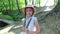 Cute little girl in a green park, forest, garden. summer.