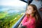 Cute little girl having a cableway ride to Tegelberg mountain, a part of Ammergau Alps, located nead Fussen town, Germany.