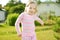 Cute little girl having fun on the backyard on sunny summer evening