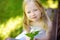 Cute little girl having fun on the backyard on sunny summer evening